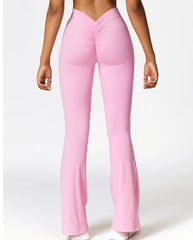 Pink flared pants worn by a person - close-up