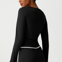 Black long-sleeve top worn by a person side view