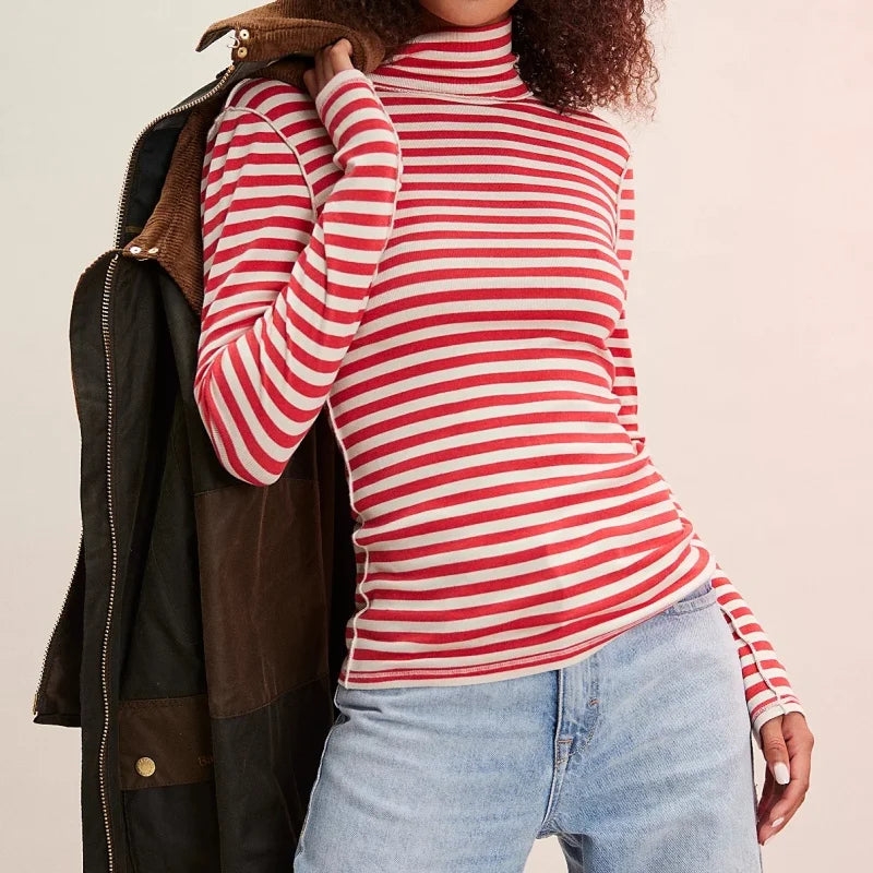 Person wearing a red and white striped turtleneck sweater with a brown leather jacket 