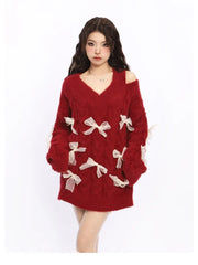 Red sweater with white bow details worn by a model 