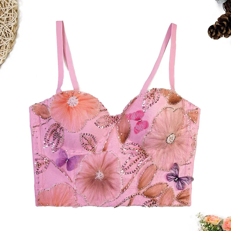 Pink floral and butterfly embellished top on a white background