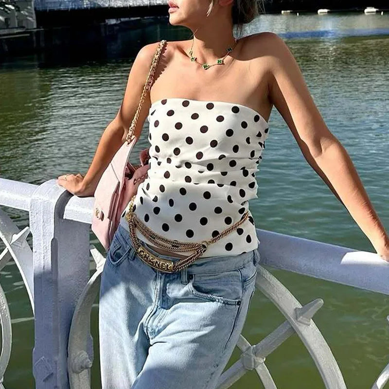 Woman wearing a polka dot top and jeans by a waterfront