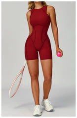 Person wearing a red athletic outfit holding a pink tennis ball and racket 
