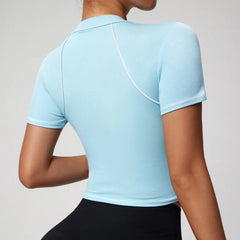 Light blue athletic top worn by a person on a plain background