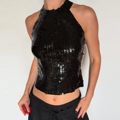 Black sequin top worn by a person on a plain background