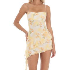 Woman wearing a yellow floral dress - camisole style, irregular hem