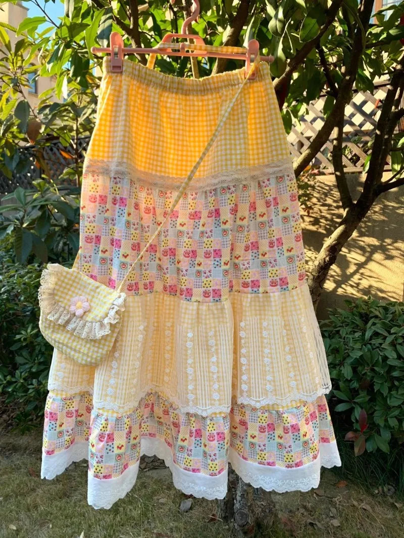 Women's yellow floral print patchwork lace maxi skirt with A-line silhouette.


