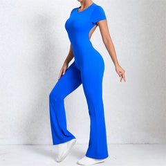 Person wearing a blue jumpsuit on a light gray background