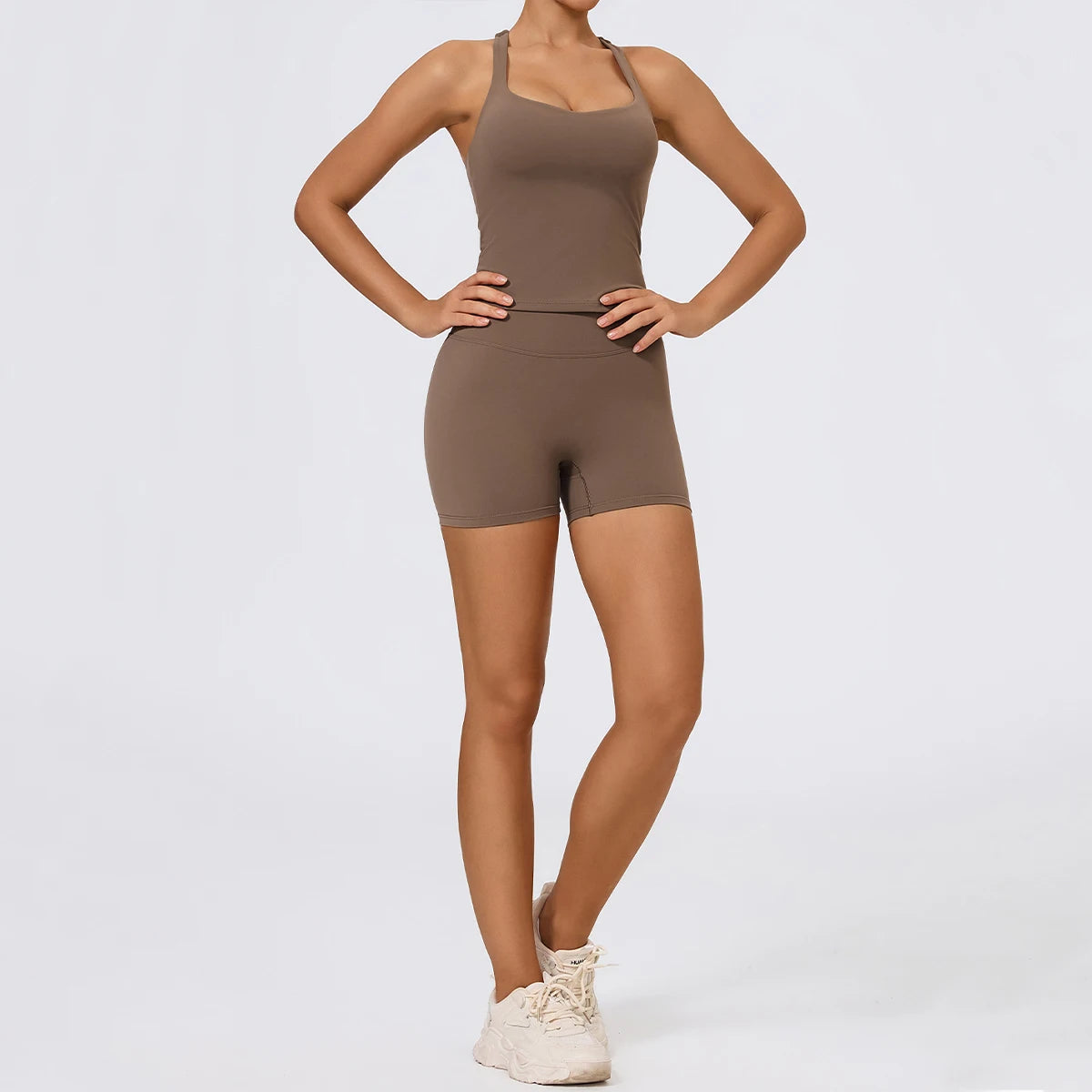 Person wearing a brown bodysuit on a light gray background