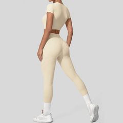 Person wearing a beige athletic outfit on a plain background
