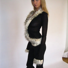 Person wearing a black outfit with fur trim 