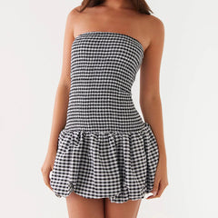Black and white checkered strapless dress on a plain background
