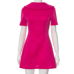 A pink short sleeve mini dress featuring an Uptown style collar, shown on model.