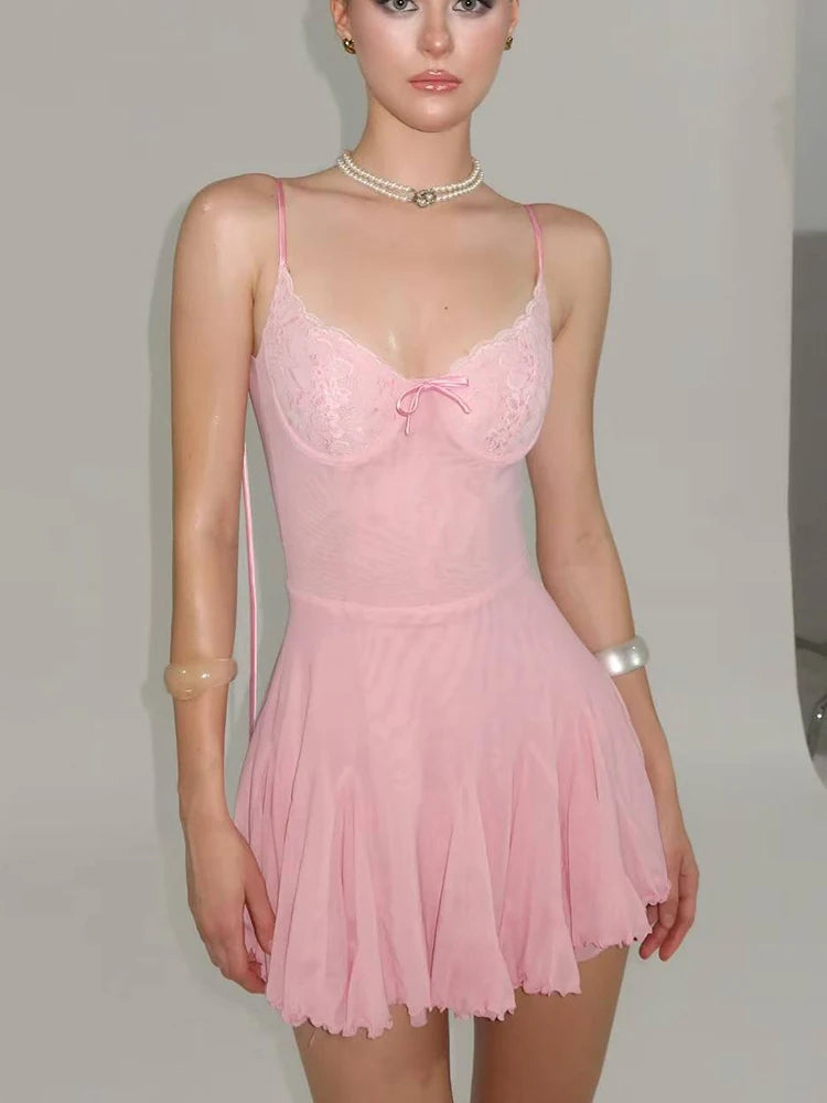 Pink lace nightgown worn by a model against a plain background
