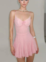 Pink lace nightgown worn by a model against a plain background
