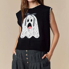 Black sleeveless sweater with a white ghost design on a beige background