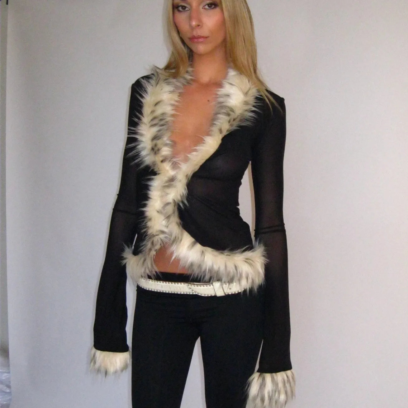 Woman wearing a black outfit with white fur trim 