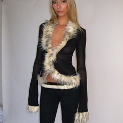 Woman wearing a black outfit with white fur trim 