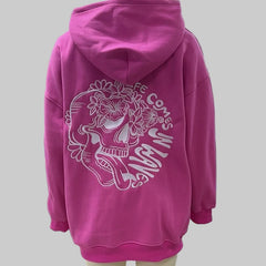 Pink hoodie with a skull design and text on a mannequin 