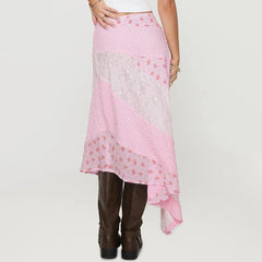 Person wearing a pink checkered skirt with floral embroidery