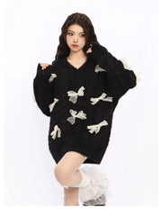 Woman wearing a black sweater with white bow patterns 