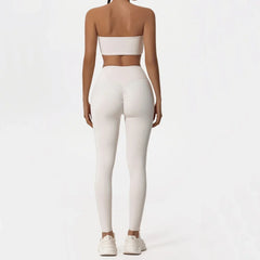 Person wearing a white strapless top and leggings- back view