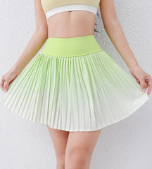Green and white pleated skirt worn by a person