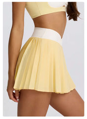 Yellow pleated skirt worn by a person 