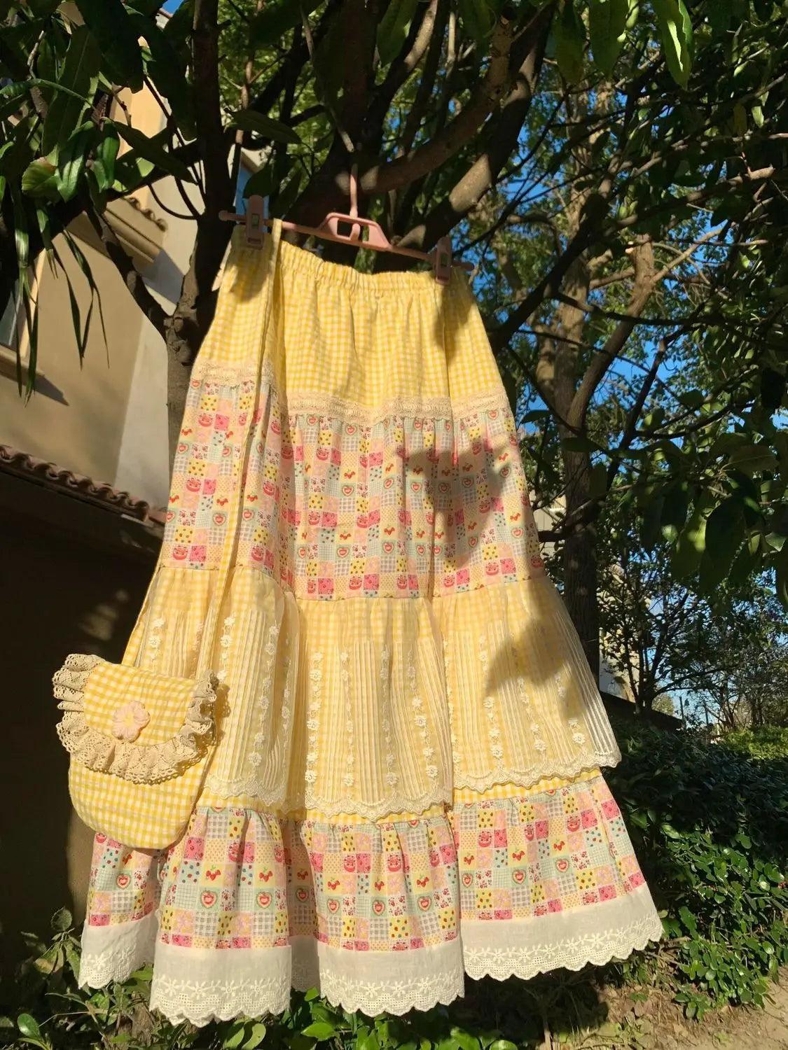Women's yellow floral print patchwork lace maxi skirt with A-line silhouette.

