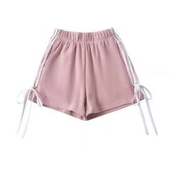 A pair of stylish shorts with a playful bow detail and a trendy striped print.