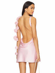 Satin mini dress with floral straps and open back.