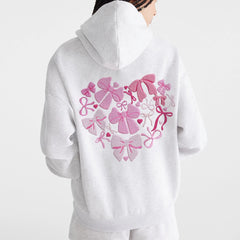 White hoodie with pink bow design 