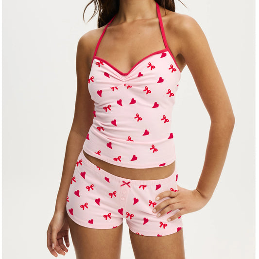 Pink pajama set with red patterns on a white background