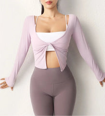 Person wearing a light purple long-sleeve top and gray leggings- full view