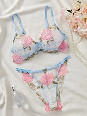 Women's lingerie set with delicate rose embroidery and sheer details.