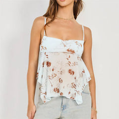 Woman wearing a floral camisole top with a plain background