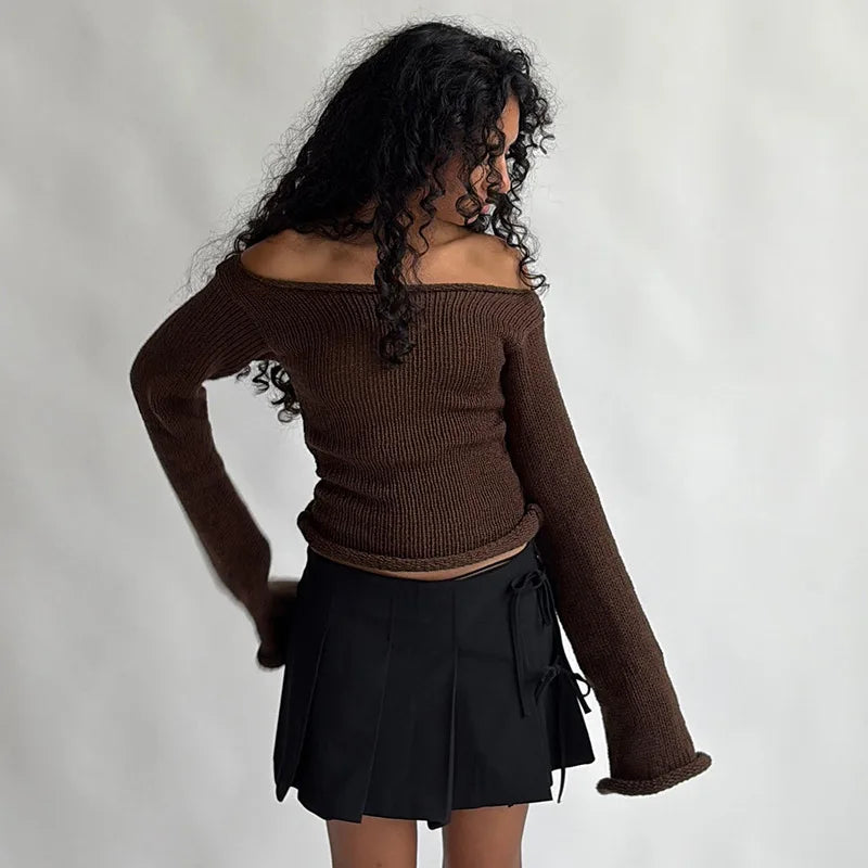 Woman wearing a brown off-shoulder sweater and black skirt 