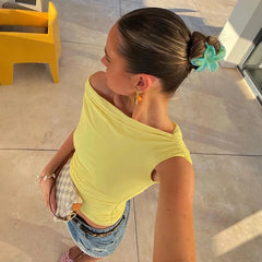A one-shoulder crop top with a drawstring and ruched detailing.