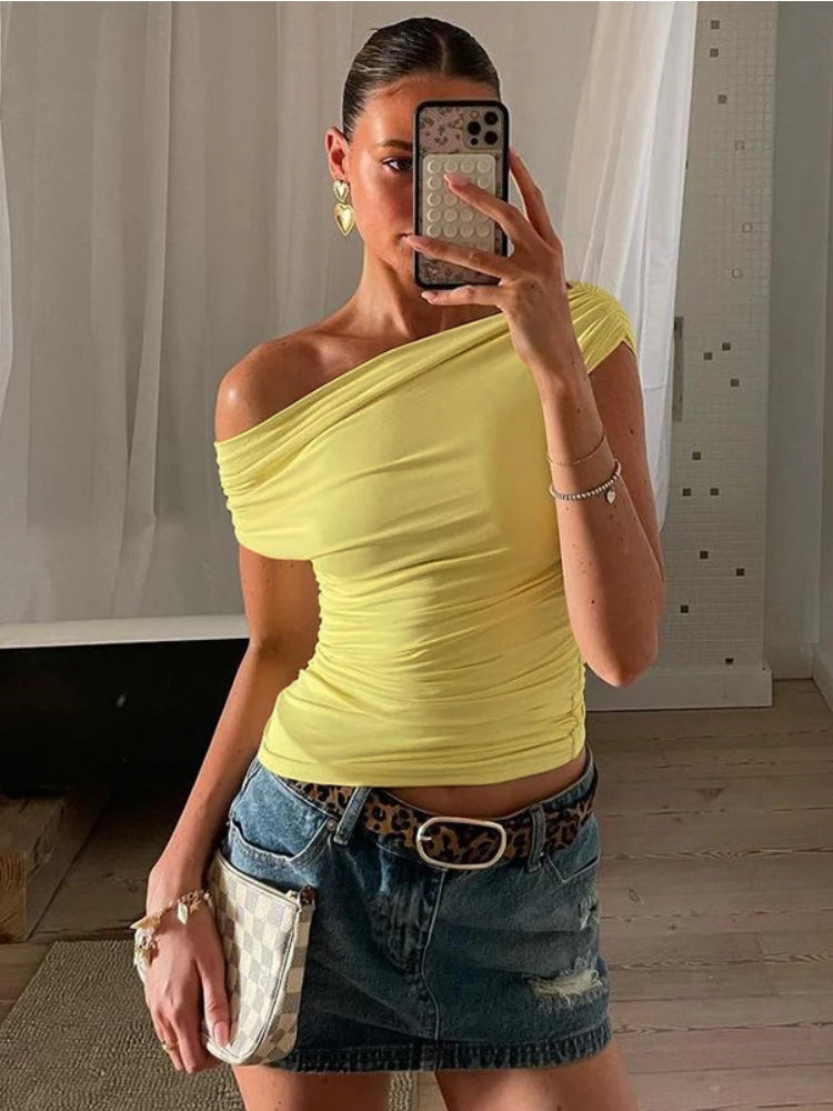 A one-shoulder crop top with a drawstring and ruched detailing.