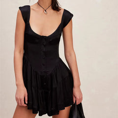Black dress worn by a person on a beige background