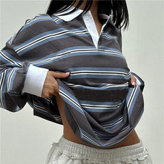 Person wearing a striped shirt with a plain background