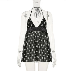 Black polka dot dress on a mannequin against a white background