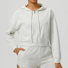 Gray hoodie and pants set on a plain background