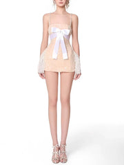 Mini dress with diamond embellishments on straps and a square neckline, styled for a night out.