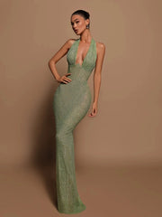 A sequin maxi dress featuring a halter neckline and deep neck, shown on model.