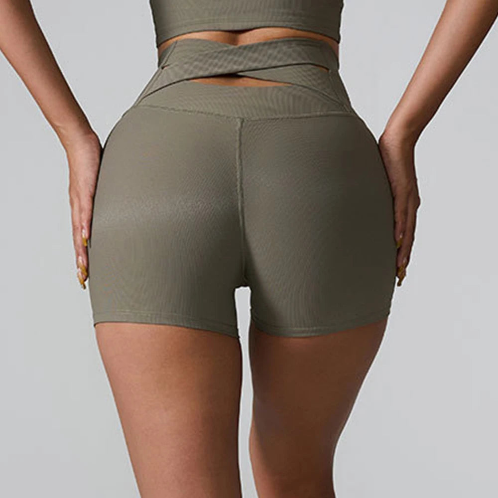 Person wearing olive green athletic shorts - back view