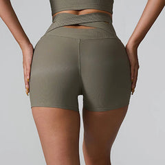 Person wearing olive green athletic shorts - back view