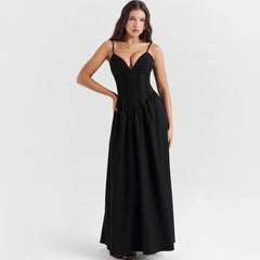 A woman wearing a flattering black maxi dress with a flowing silhouette, perfect for a special occasion or a night out.