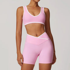 Person wearing a pink sports bra and shorts set 