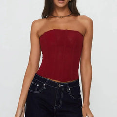 Woman wearing a strapless red top and dark jeans- close-up